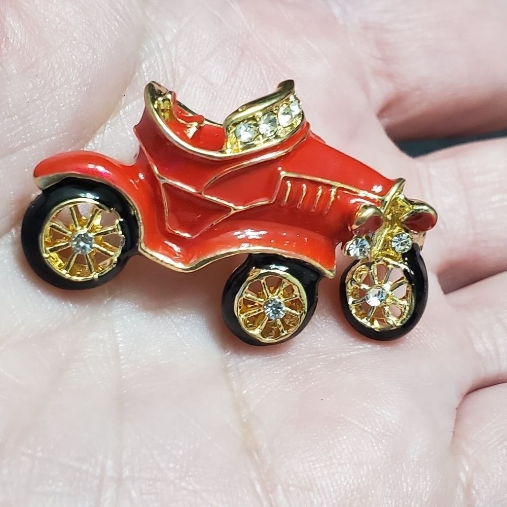 Gold tone red enamel antique car brooch